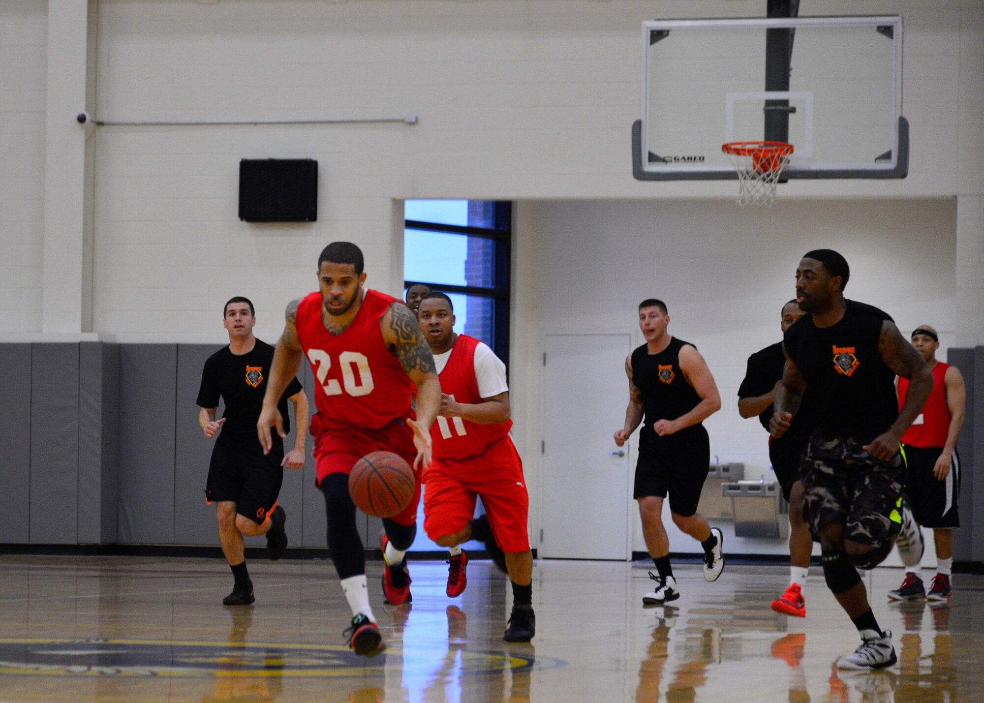 Deramus Taylor, 436th Force Support Squadron/512th Airlift Wing small forward, dribbles the ball down the court during the intramural basketball championship game against the 436th Aerial Port Squadron March 1, 2016, at the Fitness Center on Dover Air Force Base, Del. The 436th FSS/512th AW lost to the 436th APS in the first round of playoffs and lost to them again in the championship game, 82-73. (U.S. Air Force photo/Senior Airman William Johnson)
