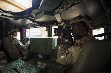 Staff Sgt. Paul Labbe, 1st Combat Camera Squadron combat photojournalist, takes a photo inside a High Mobility Multipurpose Wheeled Vehicle egress simulator March 3, 2016, during exercise Scorpion Lens 2016, at McCrady Training Center, Fort Jackson, South Carolina. The exercise is an annual training requirement incorporating combat camera job qualification standards and advanced weapons and tactical training with Army instructors. (U.S. Air Force photo/Staff Sgt. Jared Trimarchi)
