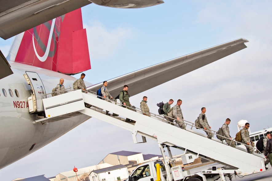 Members of the 5th Bomb Wing exit an aircraft at Minot Air Force Base, N.D., March 4, 2016 returning from Andersen Air Base, Guam. Air Force Global Strike Command continues to routinely deploy bombers to Andersen AB which provides opportunities for our Airmen to advance and strengthen regional alliances and our long-standing military-to-military partnerships throughout the Indo-Asia-Pacific. (U.S. Air Force photo/Airman 1st Class J.T. Armstrong)