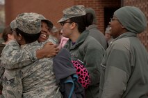 Senior Airman Halina Nichols, (left) an Airman assigned to the 5th Bomb Wing, reunites with friends at Minot Air Force Base, N.D., March 4, 2016. Nichols, as well as approximately 275 Airmen and four B-52H Stratofortresses, returned from a six month deployment to Andersen Air Force Base, Guam. (U.S. Air Force photo/Airman 1st Class Jessica Weissman))