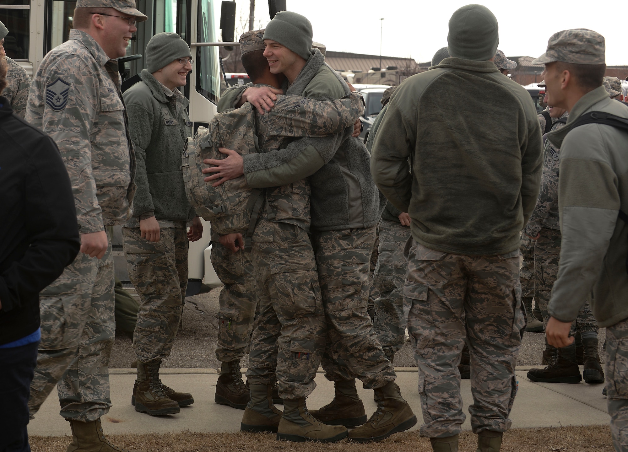 Amn Penielmichael David, (left) an Airman assigned to the 5th Bomb Wing, is greeted by his wingmen at Minot Air Force Base, N.D., March 4, 2016. David, as well as approximately 275 Airmen and four B-52H Stratofortresses, returned from a six month deployment to Andersen Air Force Base, Guam. (U.S. Air Force photo/Airman 1st Class Jessica Weissman)