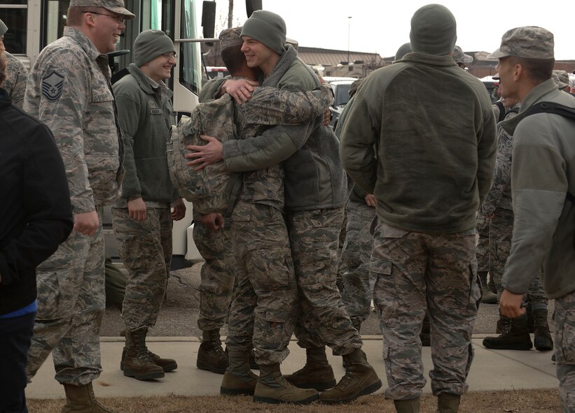 Amn Penielmichael David, (left) an Airman assigned to the 5th Bomb Wing, is greeted by his wingmen at Minot Air Force Base, N.D., March 4, 2016. David, as well as approximately 275 Airmen and four B-52H Stratofortresses, returned from a six month deployment to Andersen Air Force Base, Guam. (U.S. Air Force photo/Airman 1st Class Jessica Weissman)