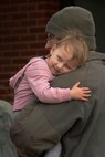 Staff Sgt. Toby Kourtney, an Airman assigned to the 5th Bomb Wing, reunites with his daughter, McKinley. Kourtney, as well as approximately 275 Airmen and four B-52H Stratofortresses, returned from a six month deployment to Andersen Air Force Base, Guam. (U.S. Air Force photo/Airman 1st Class Jessica Weissman)