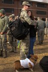 Senior Airman Jacob Dumbrill, an Airman assigned to the 5th Bomb Wing, greets his girlfriend Heather Fritch and dog, Tucker. Dumbrill, as well as approximately 275 Airmen and four B-52H Stratofortresses, returned from a six month deployment to Andersen Air Force Base, Guam. (U.S. Air Force photo/Airman 1st Class Jessica Weissman)