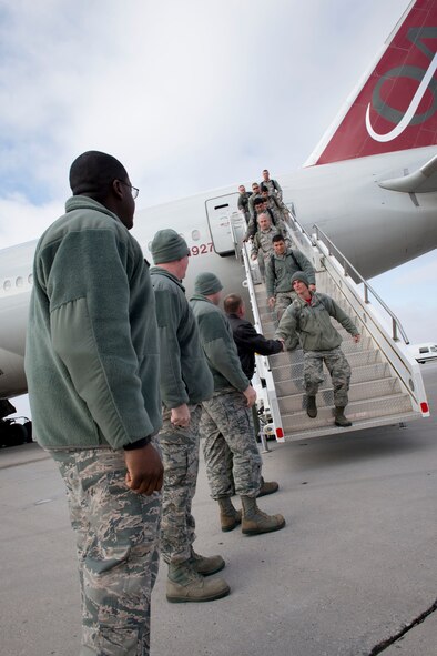 5th Bomb Wing leadership greets returning deployers as they exit a plane at Minot Air Force Base, N.D., March 4, 2016. Approximately 275 Airmen and four B-52H Stratofortresses returned after a six month deployment to Andersen Air Force Base, Guam. (U.S. Air Force photos/Senior Airman Sahara Fales)