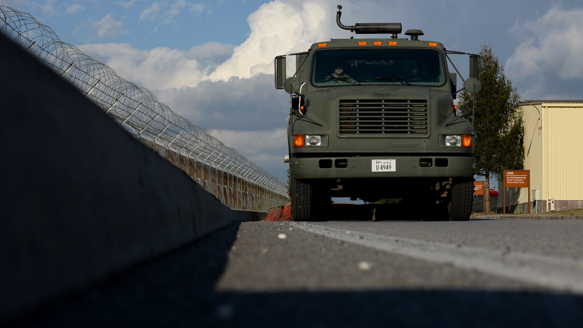 Staff Sgt. Lee Thorpe, 31st Civil Engineer Squadron heavy equipment supervisor, sweeps up street debris, March 1, 2016, at Aviano Air Base, Italy. The horizontal repair section uses street sweepers to help keep the flightline and roads clean. (U.S. Air Force photo by Airman 1st Class Cary Smith/Released) 