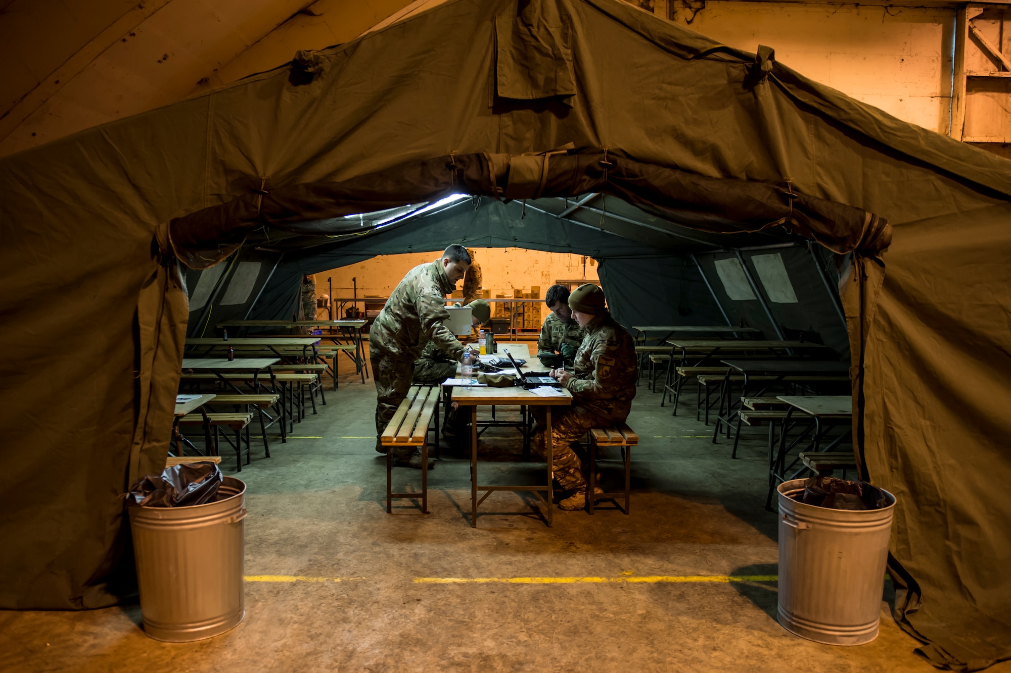 Airmen from the 56th Rescue Squadron debrief after a night flight during exercise Voijek Valour at Hullavington Airfield, England, March 3, 2016. The exercise included six helicopters, 250 British soldiers and more than a dozen jets conducting scenarios across Salisbury Plain. (U.S. Air Force photo/Airman 1st Class Erin R. Babis)