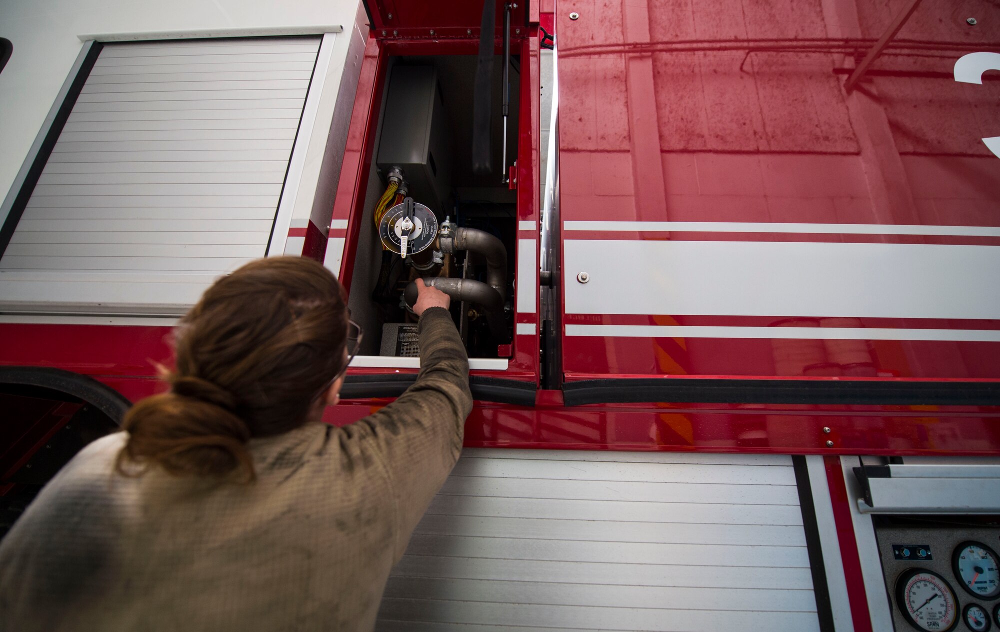 Senior Airman Nicole Franklin, 424th Air Base Squadron special vehicle mechanic, inspects the no-foam system on a Striker 1500 firetruck at Chièvres Air Base, Belgium, Feb. 26, 2016. Airmen with the 424th ABS provide airfield operations support for the Supreme Allied Commander Europe and Supreme Headquarters Allied Powers Europe (SHAPE), NATO transient aircraft and distinguished visitors. (U.S. Air Force photo/Staff Sgt. Sara Keller)