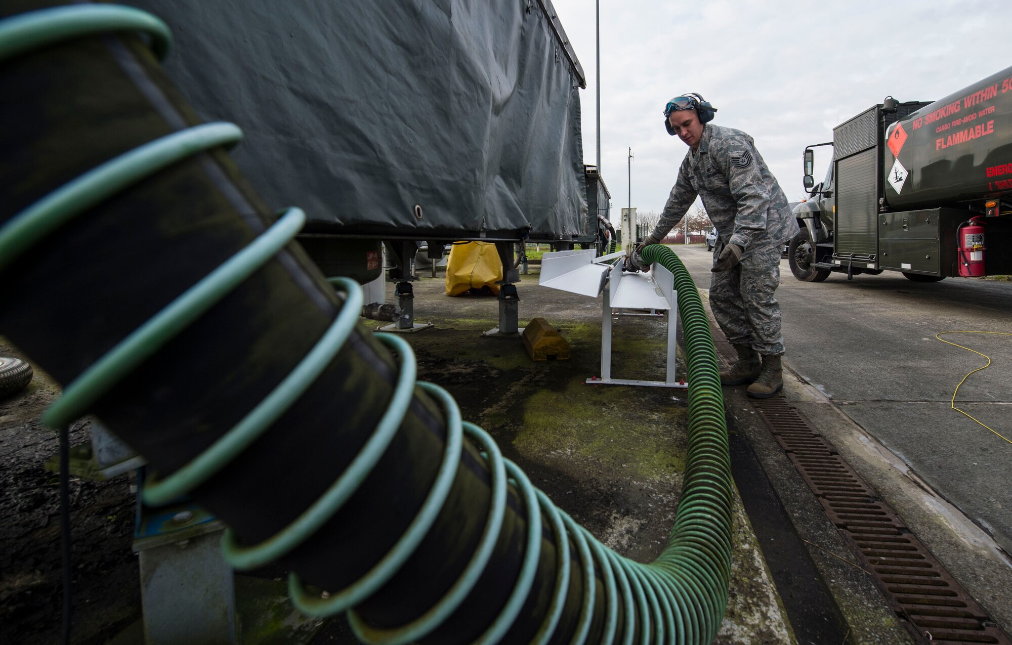 Tech. Sgt. Marcus Romero, 424th Air Base Squadron fuels management technician, stows a hose after refilling a fuel truck at Chièvres Air Base, Belgium, Feb. 25, 2016. Romero is one of 70 Airmen assigned to the 424th ABS. (U.S. Air Force photo/Staff Sgt. Sara Keller)