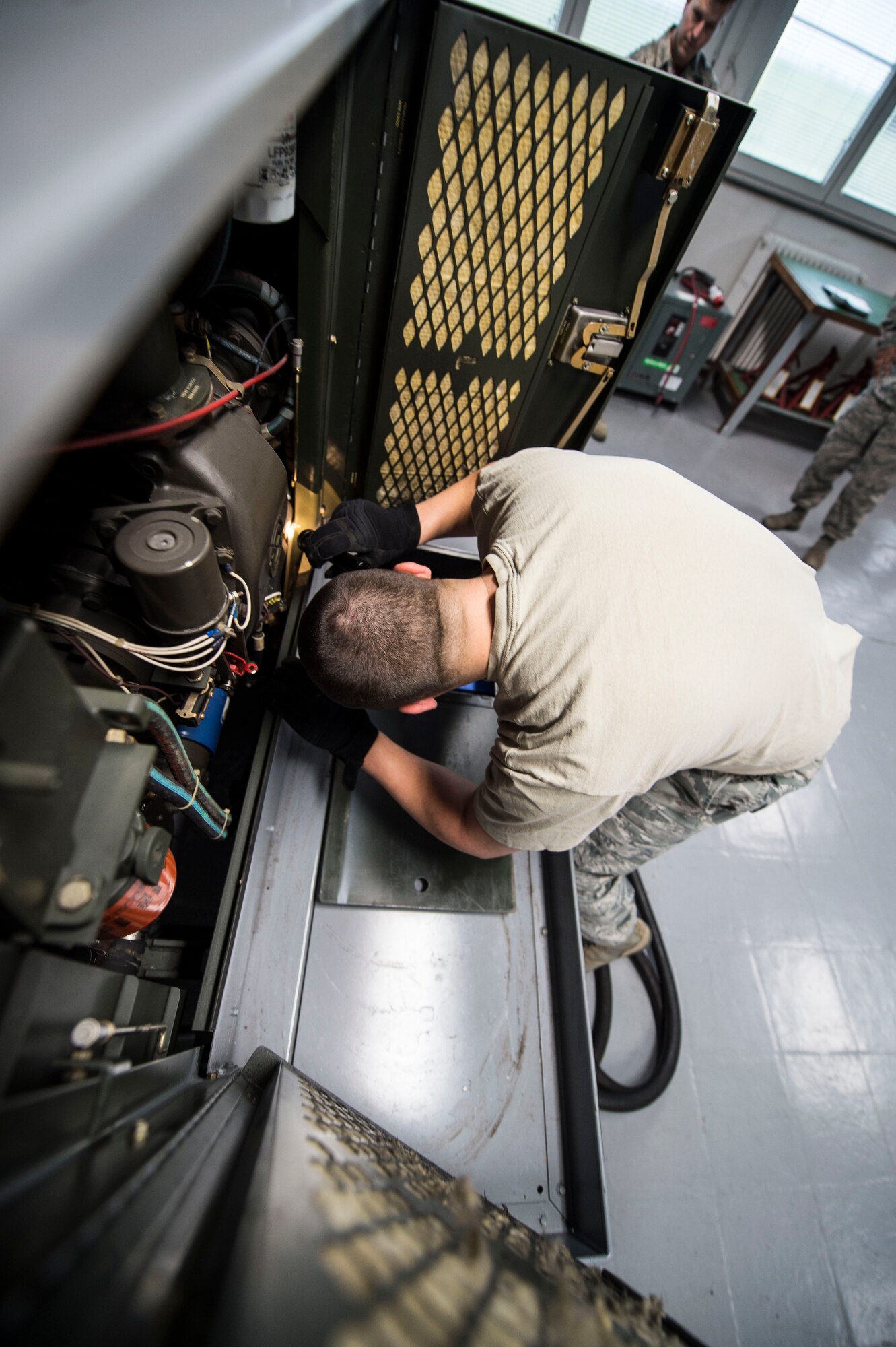 Staff Sgt. Andrew Bublik, 424th Air Base Squadron aerospace ground equipment craftsman, performs a phase inspection on a diesel generator used to power aircraft at Chièvres Air Base, Belgium, Feb. 26, 2016. AGE is one of the 18 career fields employed in the squadron that functions as the senior airfield authority for the airfield on behalf of the U.S. (U.S. Air Force photo/Staff Sgt. Sara Keller)