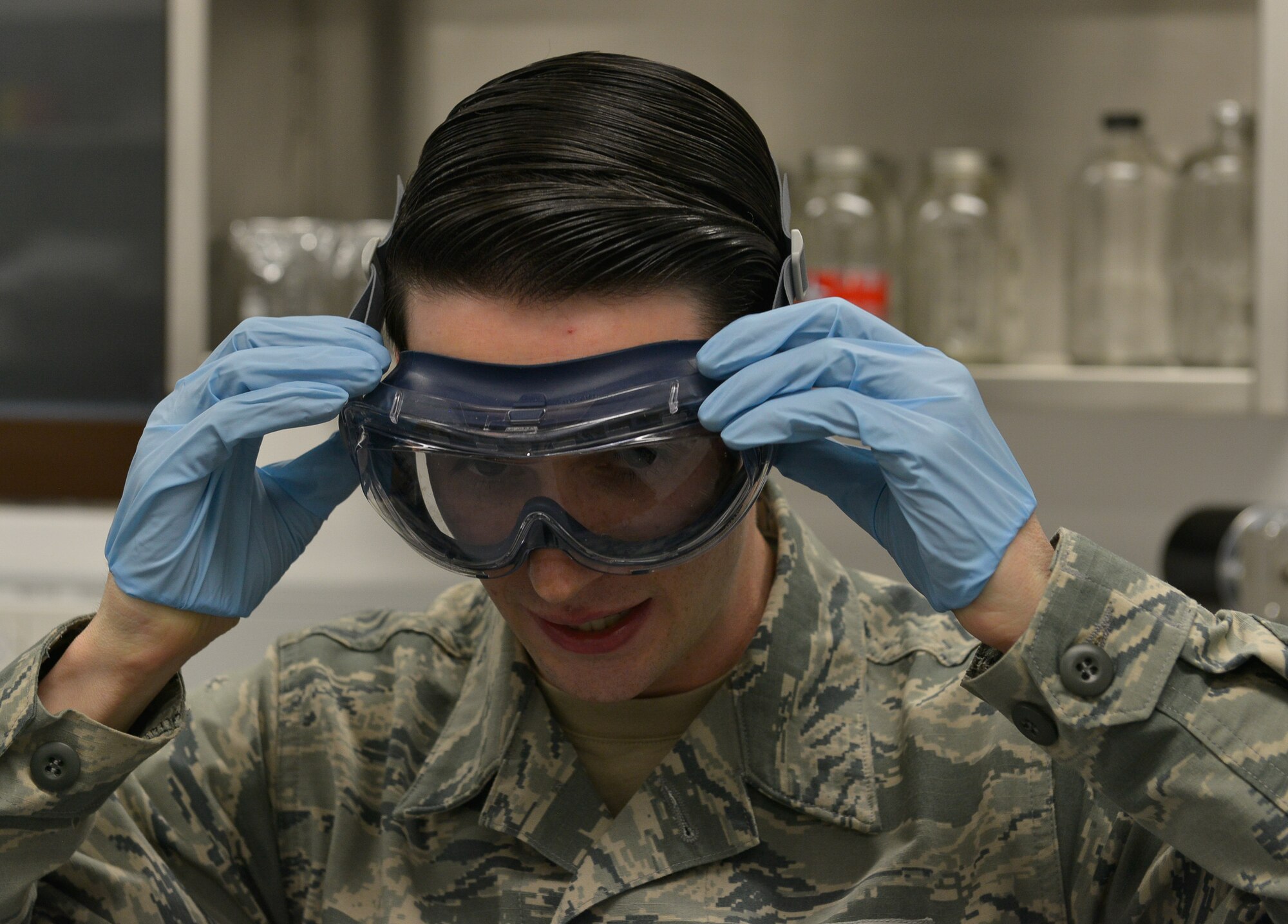 Senior Airman Matthew Jameson, 86th Logistics Readiness Squadron fuels laboratory technician, straps on goggles as he prepares to test fuel samples Mar. 3, 2016, at Ramstein Air Base, Germany. The new fuel laboratory under the 86th LRS opened after 16 months of renovations and comes with new equipment and more space for Airmen to work in. (U.S. Air Force photo/Airman 1st Class Lane T. Plummer)