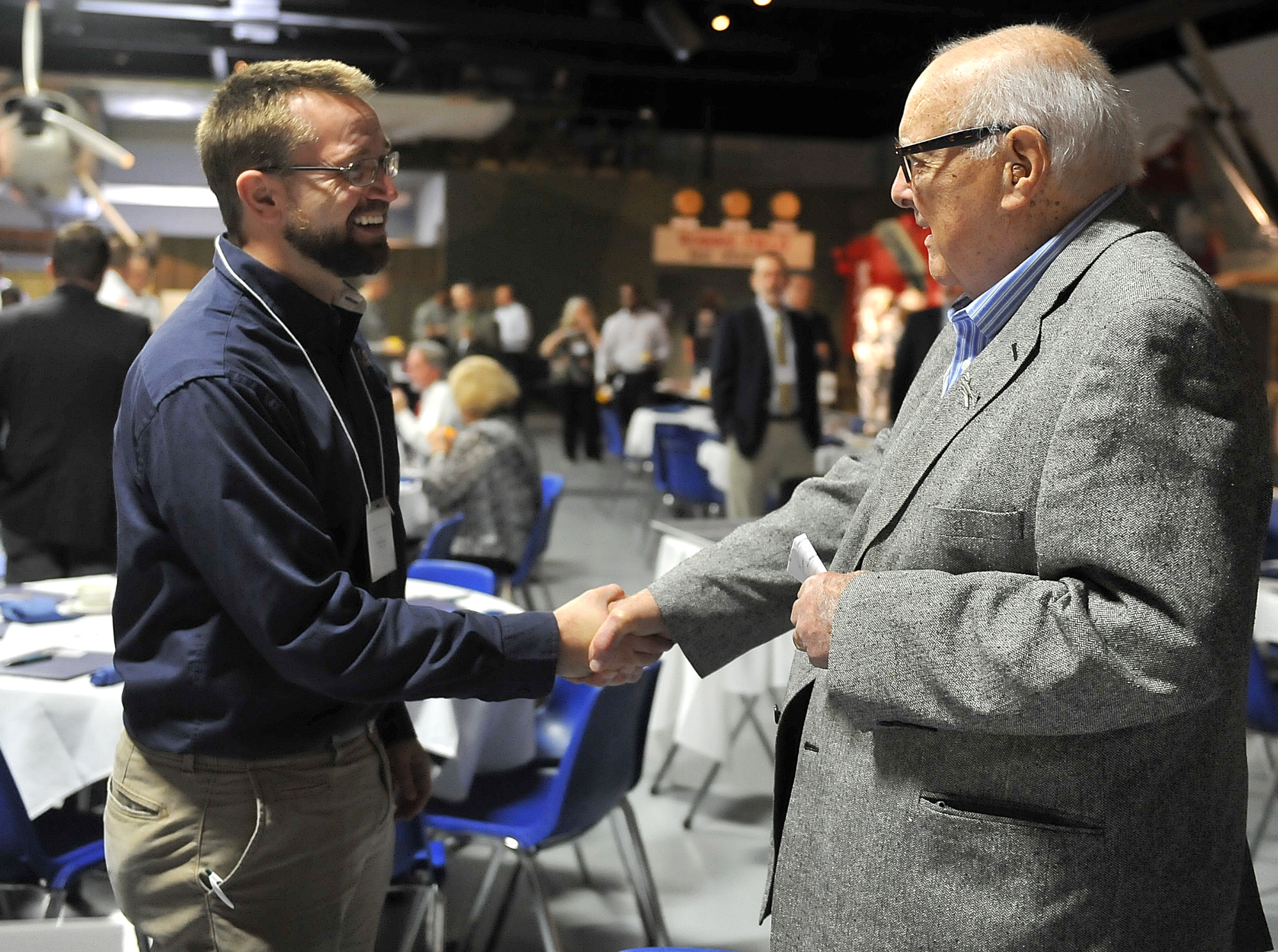 Rev. Chris Young, Central Baptist Church teaching and families associate pastor, left, greets Crawford Hicks, World War II Air Force pilot, following a clergy summit at the Museum of Aviation, March 1, 2016. Hicks was a guest speaker at the event which attracted about 100 local clergy and Team Robins members.   (U.S. Air Force photo by Tommie Horton)