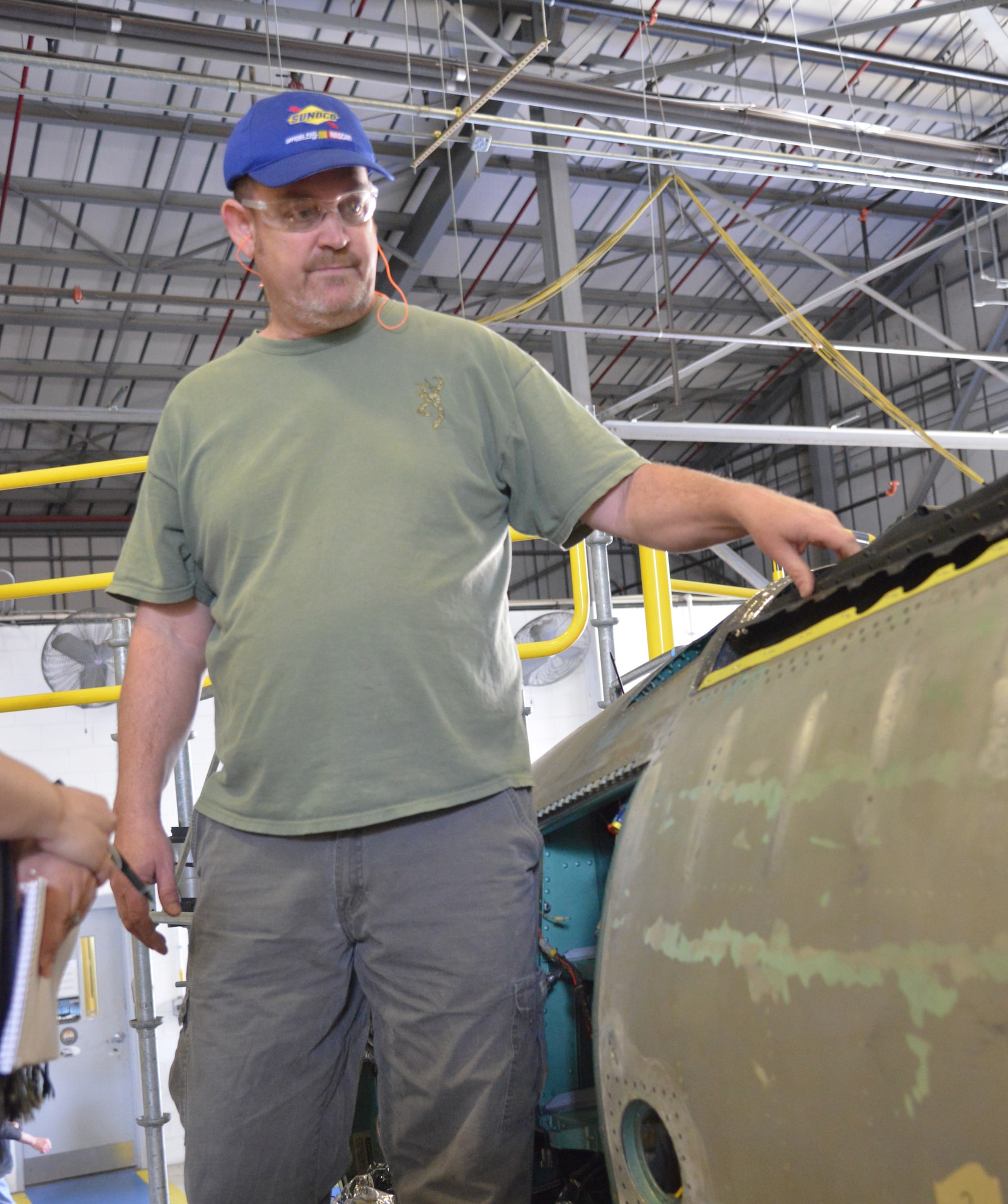 Craig Wright, 561st Aircraft Maintenance Squadron sheet metal mechanic, explains the process for longeron removal and replacement. (U.S. Air Force photo by Ray Crayton)