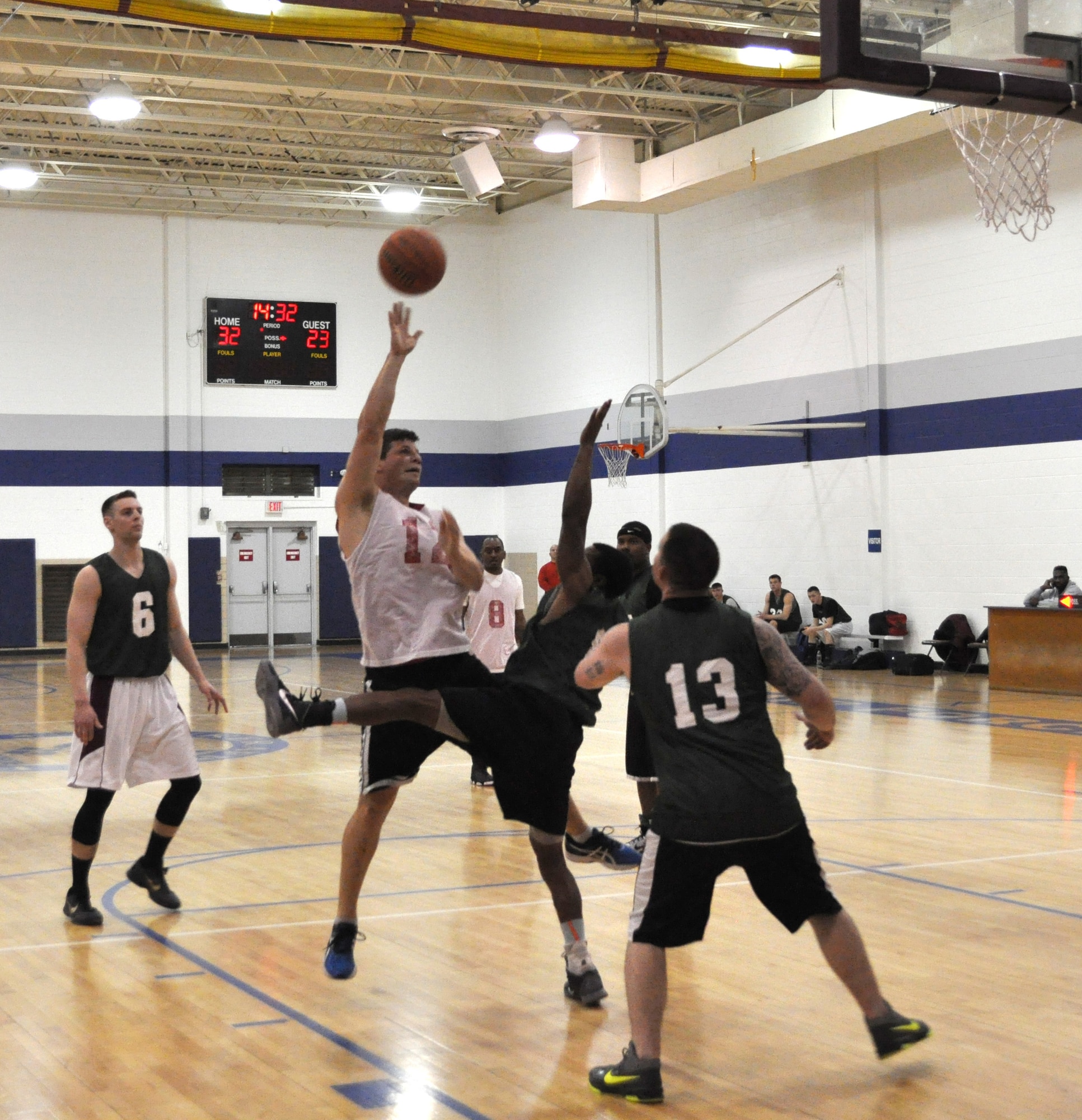 Flight Controllers’ Sean Trosper falls back with a jumper over two 552 MXS defenders Feb. 24 at the Gerrity Fitness Center. The Controllers won 56-43. (Air Force photo by John Parker)