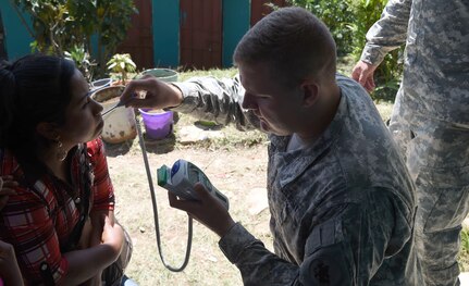 LA PAZ, Honduras - U.S. Army Sgt. Phillip Hodges, Joint Task Force-Bravo Medical Element medical logistic specialist, checks a patient’s temperature during a Medical Readiness Training Exercise in La Paz Department, Honduras, March 1, 2016.  These training exercises allow U.S. Servicemembers to improve their medical skills under austere conditions, improving their mobile and response capacities, while engaging with the local community and supporting the Honduran medical providers. (U.S. Army photo by Martin Chahin/Released).