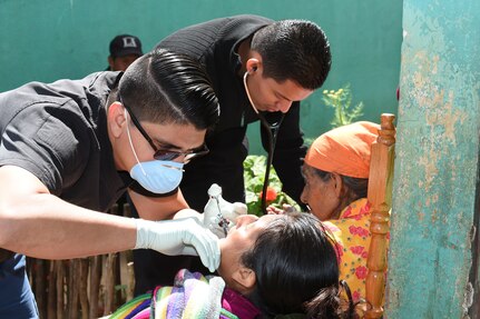 LA PAZ, Honduras – Honduran physicians, Dr. Jose Elias Dubón (front) and Dr. Oscar Quezada (back) provide dental and medical services to two patients during a Medical Readiness Training Exercise in La Paz Department, Honduras, March 2, 2016. During the two-day exercise patients received basic dental and medical treatment, as well as an initial health class where they were given vitamins and deworming medication. (U.S. Army photo by Martin Chahin/Released)