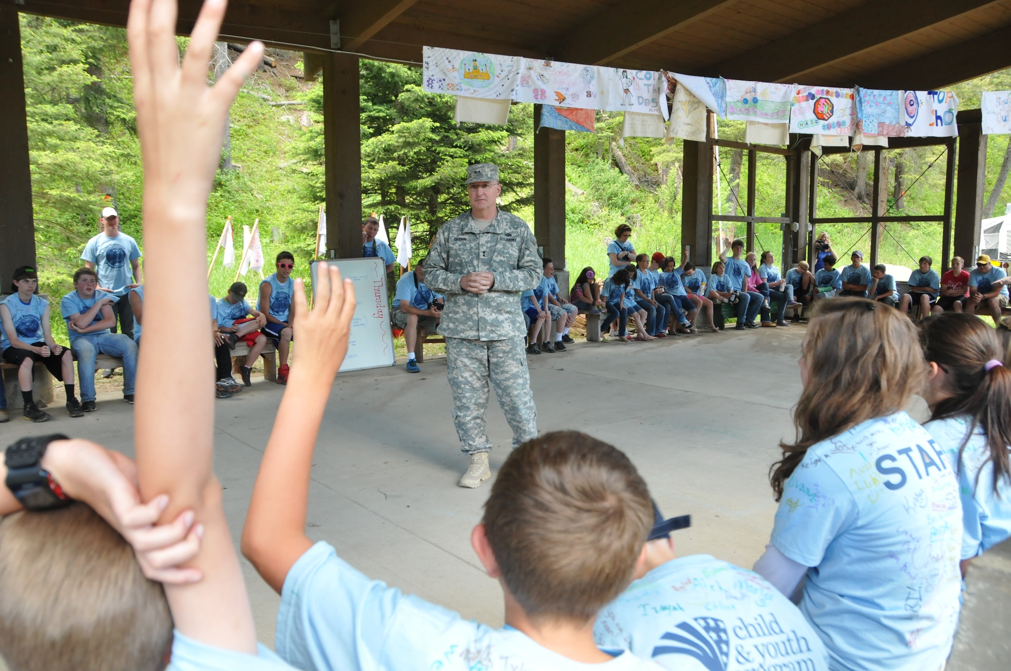 Campers ask questions of the Adjutant General of Montana, Maj. Gen. Matthew Quinn, during his visit to Camp Runnamucka, located near Monarch, Mont. June 27, 2013. The camp is put on by the Montana National Guard Child and Youth Program and serves children of National Guard members who have deployed. (U.S. Air National Guard photo by Senior Master Sgt. Eric Peterson)