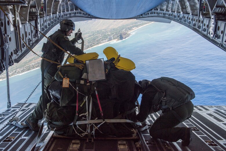 HONOLULU, Hawaii -- 249th Airlift Squadron loadmasters prepare cargo to be released from a C-17 Globemaster III here Feb. 23, 2016, off the coast of Oahu. Almost 50 Alaska Air Guardsman of the 249th Airlift Squadron, 212th Rescue Squadron and 176th Wing support units participated in a search and rescue exercise in the Pacific Air Forces' warmer waters of Honolulu, Hawaii. (U.S. Air National Guard photo by Tech. Sgt. N. Alicia Halla)