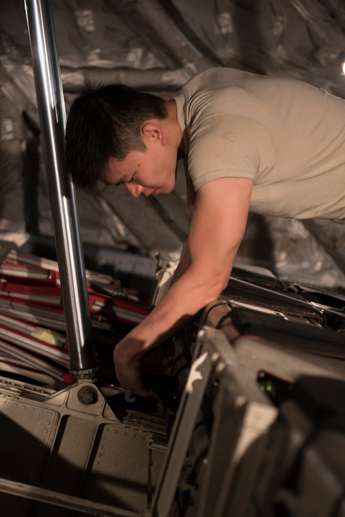 HONOLULU, Hawaii -- Airman 1st Class Arvin Ting, a crew chief with the 176th Maintenance Group, checks the security of the cargo on a C-17 Globemaster III here Feb. 23, 2016, before its next mission. Almost 50 Alaska Air Guardsman of the 249th Airlift Squadron, 212th Rescue Squadron and 176th Wing support units participated in a search and rescue exercise in the Pacific Air Forces' warmer waters of Honolulu. (U.S. Air National Guard photo by Tech. Sgt. N. Alicia Halla/Released)