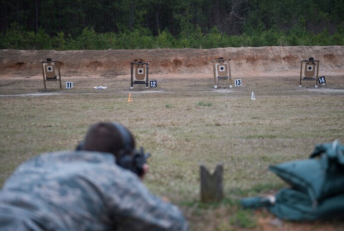 A combat camera Airman fires at a paper target March 3, 2016, during exercise Scorpion Lens 2016, at McCrady Training Center, Fort Jackson, South Carolina. The exercise is an annual training requirement incorporating combat camera job qualification standards and advanced weapons and tactical training with Army instructors. (U.S. Air Force photo/Staff Sgt. Jared Trimarchi)

