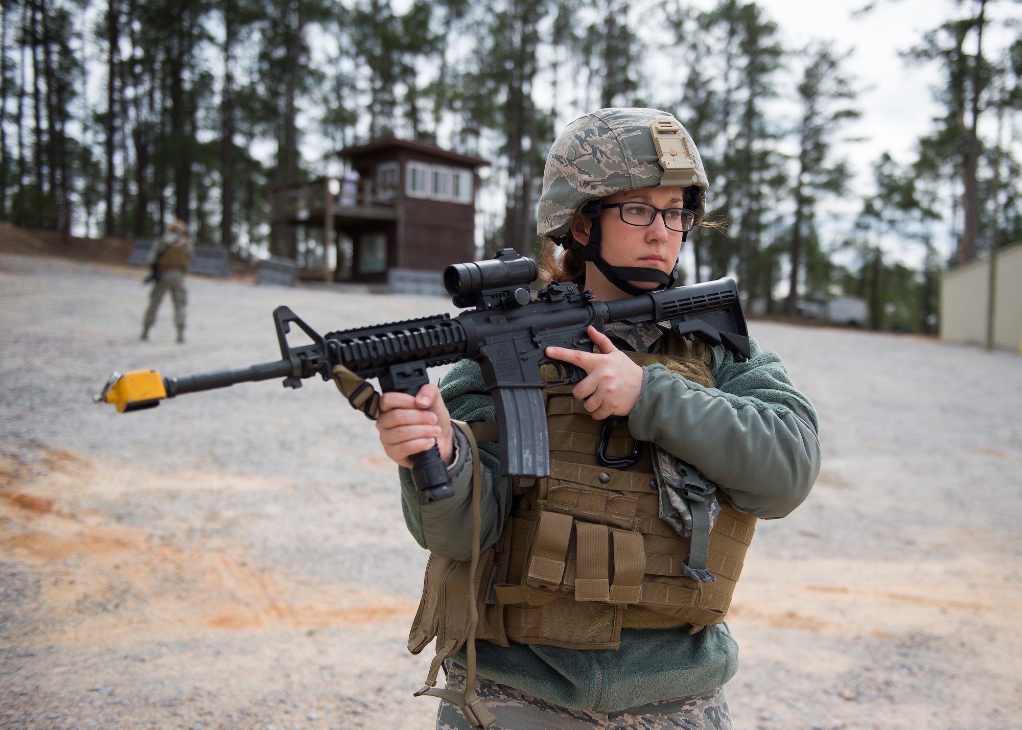 Airman Brittany Gould, a combat broadcast journalist from the 3rd Combat Camera Squadron,  listens to an instructor March 3, 2016, during exercise Scorpion Lens 2016, at McCrady Training Center, Fort Jackson, South Carolina. The exercise is an annual training requirement incorporating combat camera job qualification standards and advanced weapons and tactical training with Army instructors. (U.S. Air Force photo/Staff Sgt. Jared Trimarchi)
