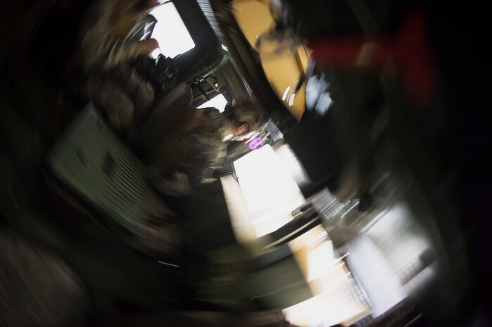 A combat camera Airman holds on in an High Mobility Multipurpose Wheeled Vehicle egress simulator March 3, 2016, during exercise Scorpion Lens 2016, at McCrady Training Center, Fort Jackson, South Carolina. The exercise is an annual training requirement incorporating combat camera job qualification standards and advanced weapons and tactical training with Army instructors. (U.S. Air Force photo/Staff Sgt. Jared Trimarchi)