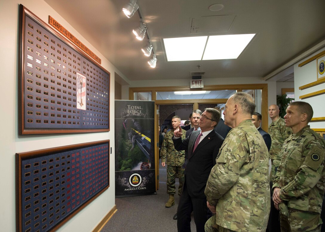 Defense Secretary Ash Carter stops to read the wall acknowledging the fallen troops of I Corps during a visit to Joint base Lewis-McChord, Wash., March 4, 2016. DoD photo by Navy Petty Officer 1st Class Tim D. Godbee