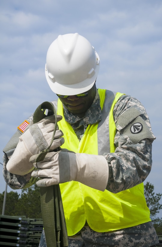 Pvt. Showan Isaacs, a cargo specialist with the 1174th Deployment and Distribution Battalion at Fort Totten, N.Y., inspects straps used to secure cargo during the Transmariner 2016 exercise in Military Ocean Terminal Sunny Point, N.C. During Transmariner, Army Reserve Soldiers receive, inspect, repackage and ready munitions for loading aboard vessels from Feb. 13 to May 21, 2016. (U.S. Army photo by Spc. Gregory Lydick/Released)