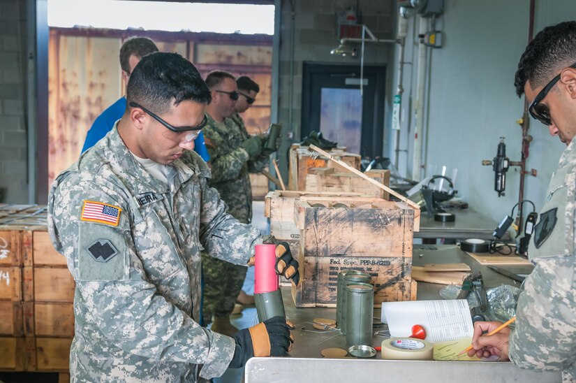 Sgt. Alexis Sierra, an ammunition specialist with the 266th Ordnance Company based in Aguadilla, Puerto Rico, inspects smoke grenades for deficiencies during Transmariner 2016 in Military Ocean Terminal Sunny Point, N.C., March 1. During Transmariner, Army Reserve Soldiers receive, inspect, repackage and ready munitions for loading aboard vessels from Feb. 13 to May 21. (U.S. Army photo by Sgt. Michael T. Crawford/RELEASED)