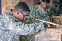 Sgt. Alexis Sierra, an ammunition specialist with the 266th Ordnance Company based in Aguadilla, Puerto Rico, repackages smoke grenades after inspecting for deficiencies during Transmariner 2016 in Military Ocean Terminal Sunny Point, N.C., March 1. During Transmariner, Army Reserve Soldiers receive, inspect, repackage and ready munitions for loading aboard vessels from Feb. 13 to May 21. (U.S. Army photo by Sgt. Michael T. Crawford/RELEASED)