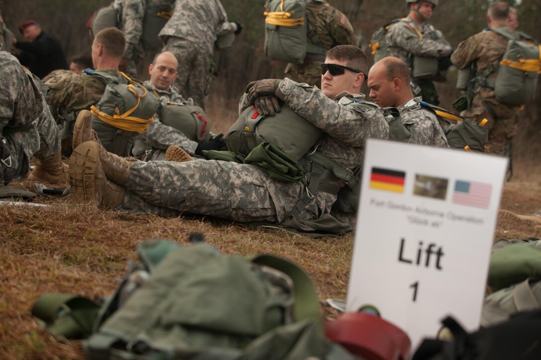 U.S. Army Paratrooper waits before a jump during Operation Glück ab!, at Fort Gordon, Ga., on March 4th, 2016. Operation Glück ab!, (OGA) is a bi-lateral airborne operation held at Fort Gordon, Ga., March 4, 2016. The purpose of OGA is to foster and nurture German and U.S. relationships, develop interoperability during training, and provide a basis for future operations in training and real world environments. The 982nd Combat Camera Company (Airborne), the 421st Quartermaster Company, and the United States Army Special Operations Command, Flight Company, Dwight D. Eisenhower Army Medical Center are providing support for OGA. (U.S. Army photo by Sgt. Jason A. Young / Released)