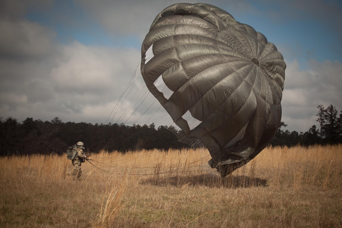 U.S. Army Paratrooper recovers equipment during Operation Glück ab!, at Fort Gordon, Ga., on March 4th, 2016. Operation Glück ab!, (OGA) is a bi-lateral airborne operation held at Fort Gordon, Ga., March 4, 2016. The purpose of OGA is to foster and nurture German and U.S. relationships, develop interoperability during training, and provide a basis for future operations in training and real world environments. The 982nd Combat Camera Company (Airborne), the 421st Quartermaster Company, and the United States Army Special Operations Command, Flight Company, Dwight D. Eisenhower Army Medical Center are providing support for OGA. (U.S. Army photo by Sgt. Jason A. Young / Released)