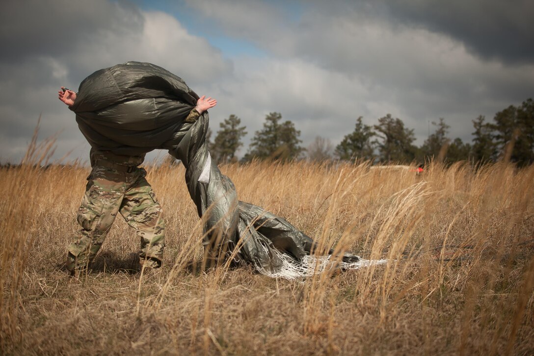 U.S. Army Paratrooper recovers equipment during Operation Glück ab!, at Fort Gordon, Ga., on March 4th, 2016. Operation Glück ab!, (OGA) is a bi-lateral airborne operation held at Fort Gordon, Ga., March 4, 2016. The purpose of OGA is to foster and nurture German and U.S. relationships, develop interoperability during training, and provide a basis for future operations in training and real world environments. The 982nd Combat Camera Company (Airborne), the 421st Quartermaster Company, and the United States Army Special Operations Command, Flight Company, Dwight D. Eisenhower Army Medical Center are providing support for OGA. (U.S. Army photo by Sgt. Jason A. Young / Released)