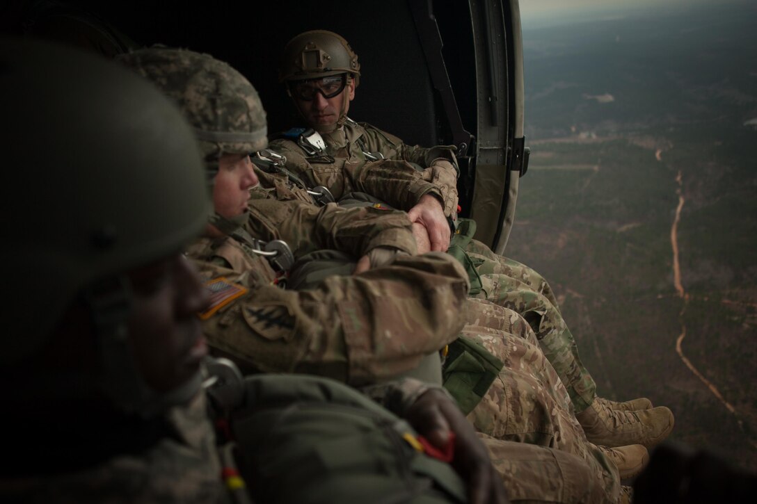 U.S. Army Staff Sgt. Justin P. Morelli, 982nd Combat Camera Company (AIRBORNE), 335th Signal Command (Theater), prepares to jump from a UH-60 Black Hawk during Operation Glück ab!, at Fort Gordon, Ga., on March 4th, 2016. Operation Glück ab!, (OGA) is a bi-lateral airborne operation held at Fort Gordon, Ga., March 4, 2016. The purpose of OGA is to foster and nurture German and U.S. relationships, develop interoperability during training, and provide a basis for future operations in training and real world environments. The 982nd Combat Camera Company (Airborne), the 421st Quartermaster Company, and the United States Army Special Operations Command, Flight Company, Dwight D. Eisenhower Army Medical Center are providing support for OGA. (U.S. Army photo by Sgt. Jason A. Young / Released)