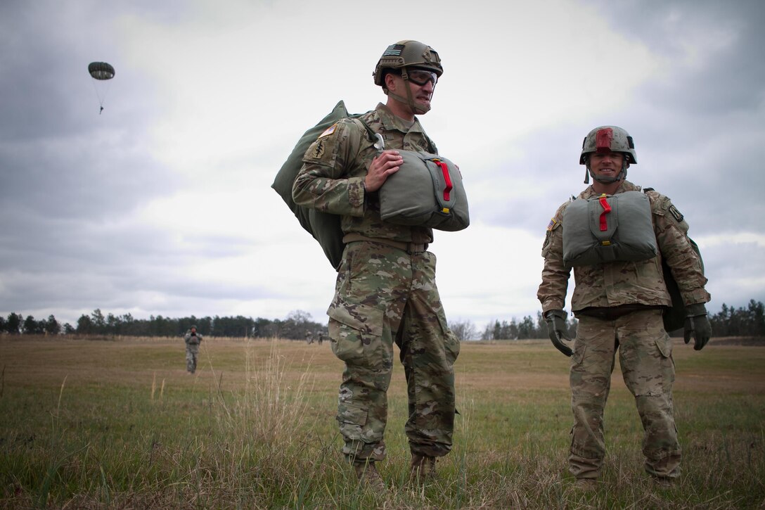 U.S. Army Paratroopers, 982nd Combat Camera Company (AIRBORNE), 335th Signal Command (Theater), prepare to leave the drop zone during Operation Glück ab!, at Fort Gordon, Ga., on March 4th, 2016. Operation Glück ab!, (OGA) is a bi-lateral airborne operation held at Fort Gordon, Ga., March 4, 2016. The purpose of OGA is to foster and nurture German and U.S. relationships, develop interoperability during training, and provide a basis for future operations in training and real world environments. The 982nd Combat Camera Company (Airborne), the 421st Quartermaster Company, and the United States Army Special Operations Command, Flight Company, Dwight D. Eisenhower Army Medical Center are providing support for OGA. (U.S. Army photo by Sgt. Jason A. Young / Released)