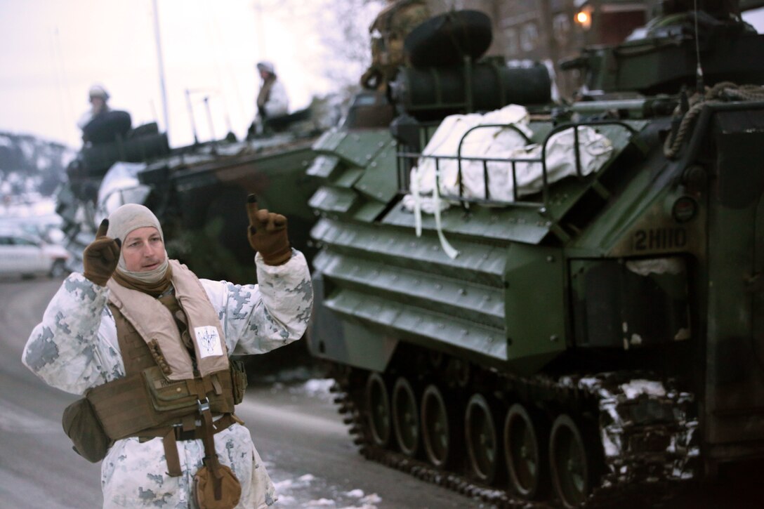 A Marine with 2nd Assault Amphibian Battalion directs a vehicle in Namsos, Norway, March 3, 2016, during Exercise Cold Response 16. The landing reinforced the unit’s capabilities of operating in winter terrain and cold-weather environments. During Cold Response, 13 NATO allies and partner nations and about 15,000 troops enhance their skill sets and strengthen their bonds.