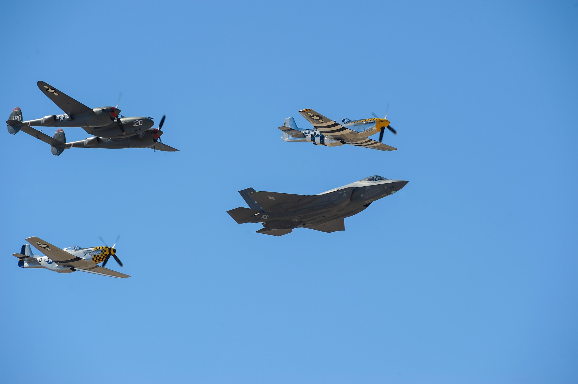 Two P-51 Mustangs, an F-35 Lightning II and a P-38 Lightning fly in formation during the 2016 Heritage Flight Training and Certification Course at Davis-Monthan Air Force Base, Ariz., March 5, 2016. Established in 1997, the HFTCC certifies civilian pilots of historic military aircraft and U.S. Air Force pilots to fly in formation together during the upcoming air show season. (U.S. Air Force photo by Airmen 1st Class Ashley N. Steffen/Released)