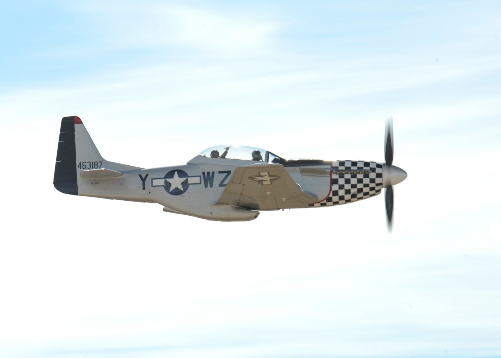 Greg Anders pilots a TF-51 mustang while U.S. Air Force Col. Jonathan Letsinger waves during the 2016 Heritage Flight Training and Certification Course at Davis-Monthan Air Force Base, Ariz., March 5, 2016. Established in 1997, the HFTCC certifies civilian pilots of historic military aircraft and U.S. Air Force pilots to fly in formation together during the upcoming air show season. (U.S. Air Force photo by Airman Nathan H. Barbour/Released)