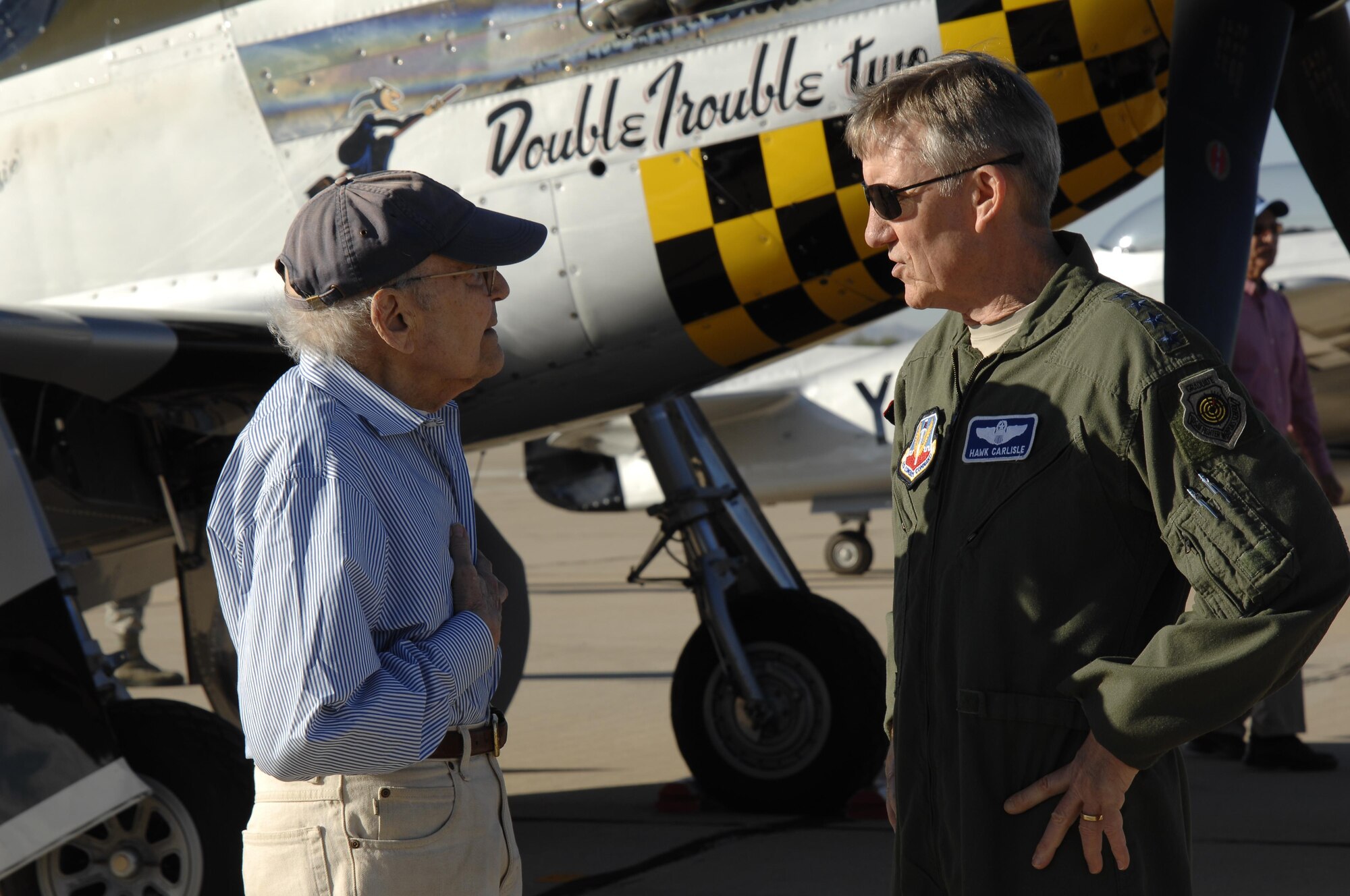 U.S. Air Force Gen. Hawk Carlisle, commander of Air Combat Command talks with U.S Air Force retired 1st Lt. William Lyons about his experience flying the P-51 Mustang during the 2016 Heritage Flight Training and Certification Course at Davis-Monthan Air Force Base, Ariz., March 5, 2016. Lyons was given a rare opportunity to sit in the aircraft he flew during World War II. (U.S. Air Force photo by Tech. Sgt. Courtney Richardson/Released)