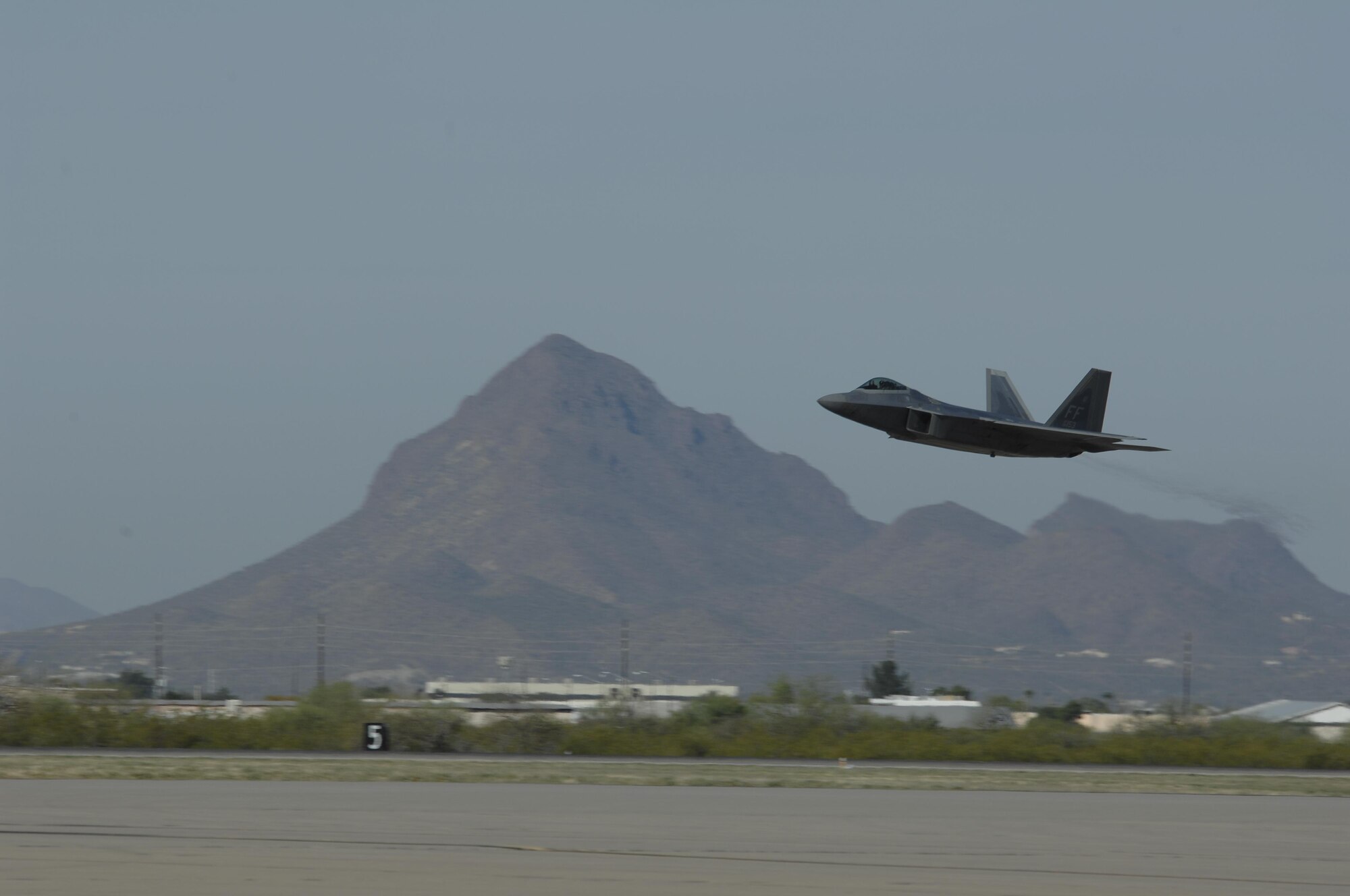 An F-22 Raptor takes off during the 2016 Heritage Flight Training and Certification Course at Davis-Monthan Air Force Base, Ariz., March 5, 2016. The annual aerial demonstration training event has been held at D-M AFB since 2001 and features historical and modern fighter aircraft flying in formation together. (U.S. Air Force photo by Tech. Sgt. Courtney Richardson/Released)