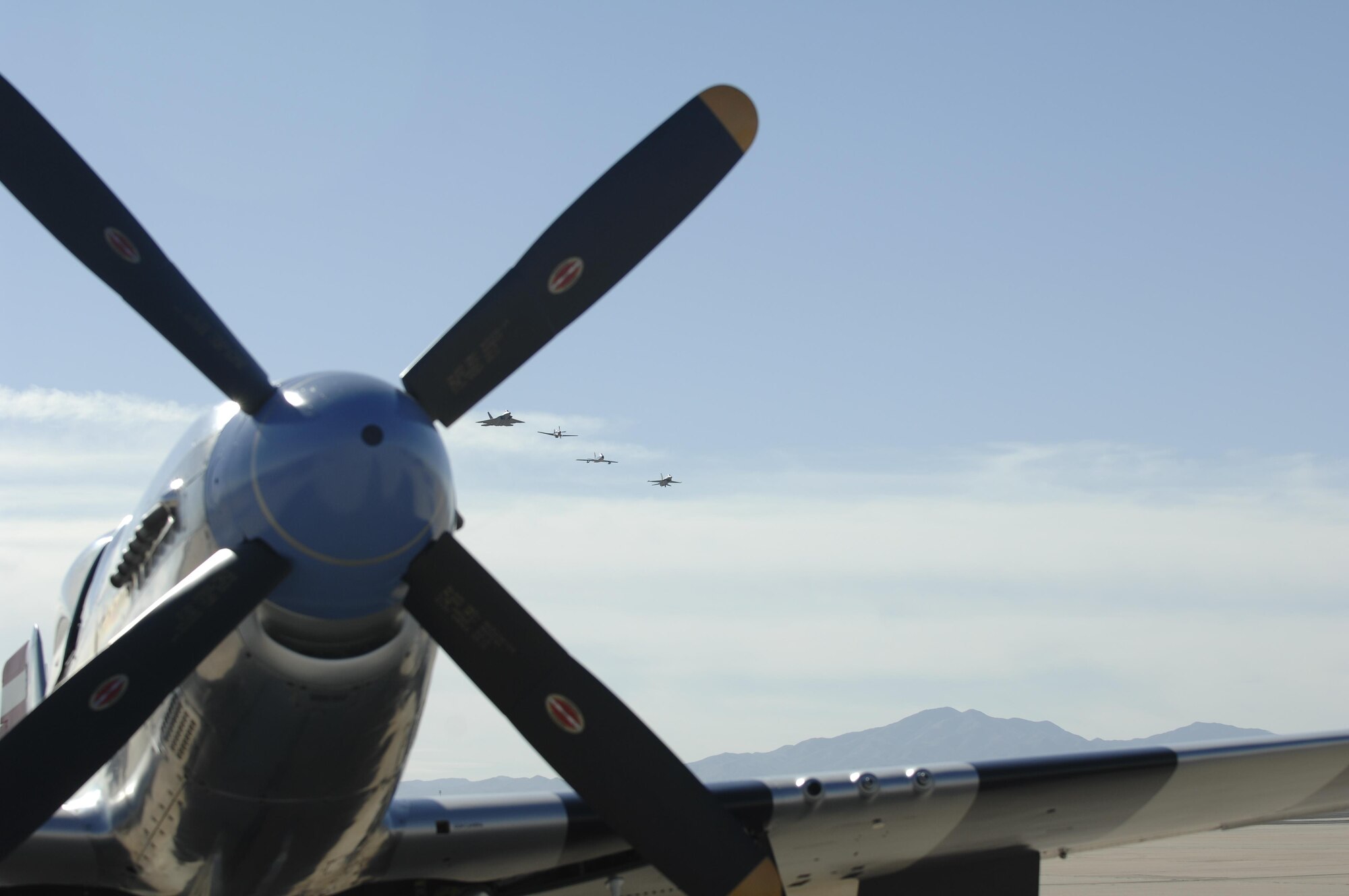 An F-22 Raptor, P-51 Mustang, F-86 Sabre, and an F-16 Fighting Falcon fly in formation during the 2016 Heritage Flight Training and Certification Course at Davis-Monthan Air Force Base, Ariz., March 5, 2016. During the course, aircrews practice ground and flight training to enable civilian pilots of historic military aircraft and U.S. Air Force pilots of current fighter aircraft to fly safely in formations together. (U.S. Air Force photo by Tech. Sgt. Courtney Richardson/Released)