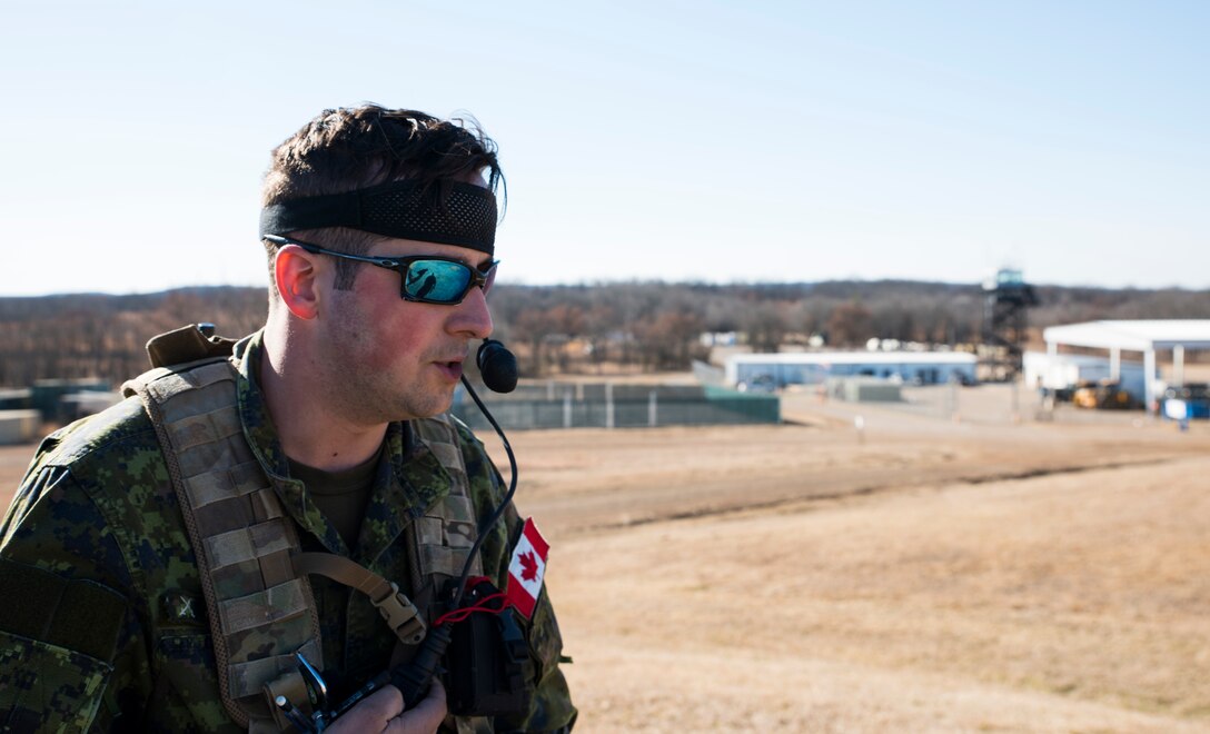 Sgt. Seth Albert, Y Battery 2nd Regiment Royal Canadian Horse Artillery joint terminal attack controller, contacts aircraft to relay ground information Feb. 10, 2016, during training held at Razorback Range, Fort Chaffee Joint Maneuver Training Center, Fort Smith, Ark. Canadian JTACs are required to train abroad at least twice a year and chose to come to Razorback Range to benefit from the wealth of training opportunities provided there. (U.S. Air National Guard photo by Senior Airman Cody Martin/Released)