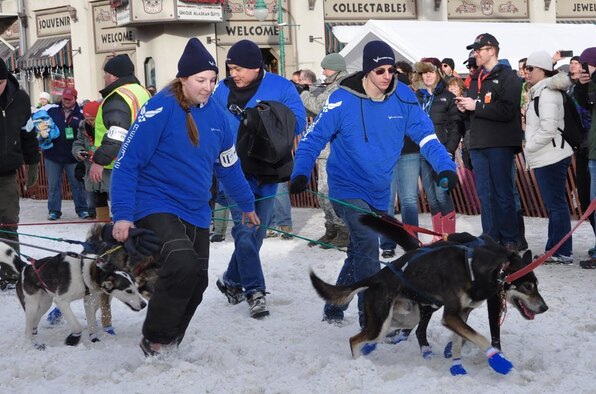 Senior Airman Sean Buono, 477th Force Support Squadron, client systems technician, Tech. Sgt. Franz Martinez,  477th FG FSS, client systems technician and Jacki Honeycutt, daughter of Chief Master Sgt. Horace Honeycutt, 477th Chief Enlisted Manager volunteered as a dog handler for an Iditarod team during the ceremonial start in Anchorage, Alaska March 5.  For the second year in a row the Air Force Reserve is a Lead Dog Sponsor for the Iditarod Race, known as The Last Great Race on Earth. The Iditarod is a 1,000-mile sled dog race across the rugged terrain of Alaska. (U.S. Air Force / Tech. Sgt. Kimberly Rae Moore)
