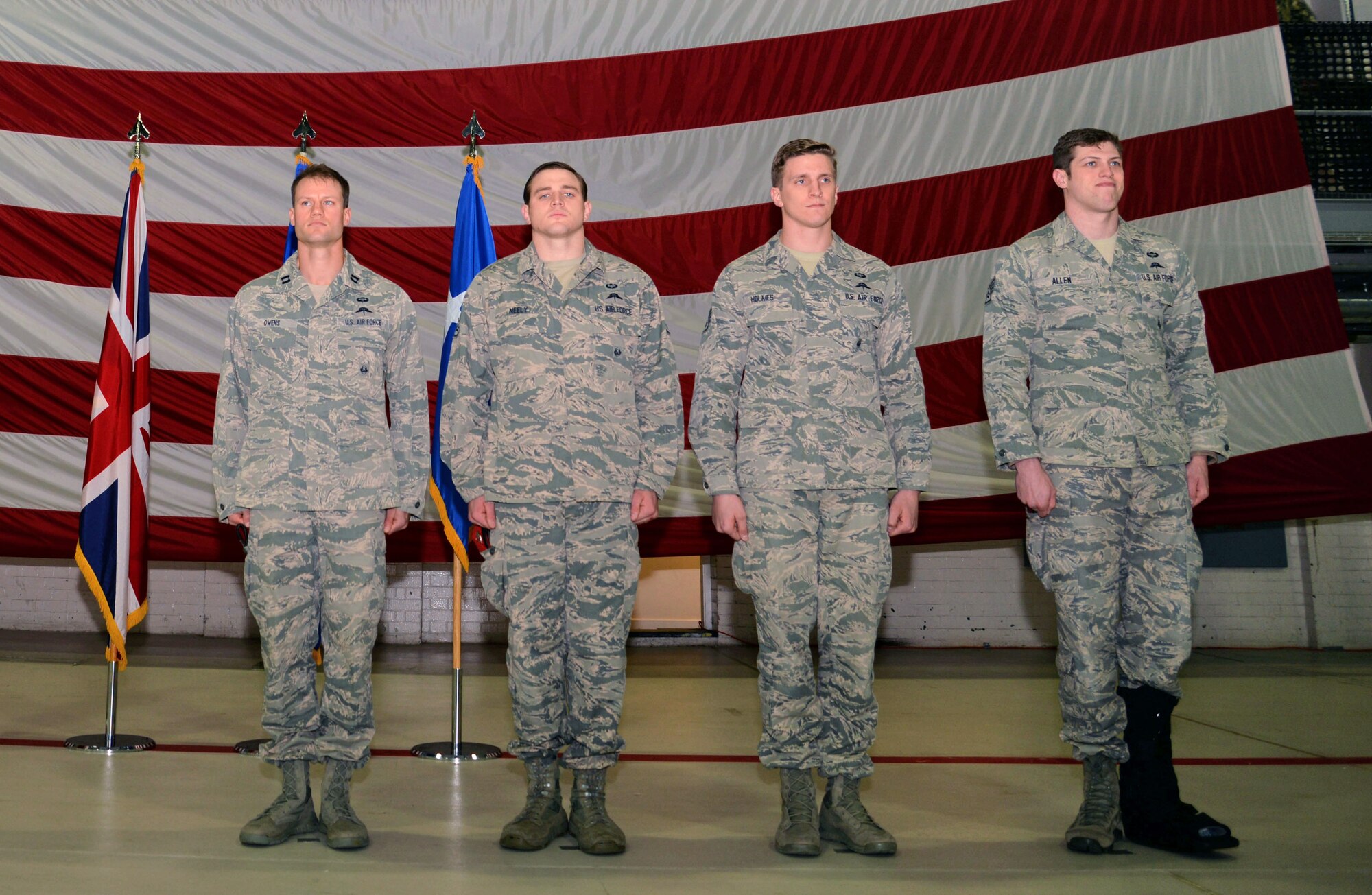 From left to right, U.S. Air Force Capt. Andrew Owens, 321st Special Tactics Squadron special tactics officer, Staff Sgt. James Neely, Staff Sgt. Ryan Holmes, and Staff Sgt. Cody Allen, all 321st STS combat controllers stand at attention during a ceremony, March 1, 2016, on RAF Mildenhall, England. Holmes and Owens received a Bronze Star for meritorious service during combat operations in Afghanistan, Neely received a Bronze Star for meritorious service in support of Operation Enduring Freedom, and Allen received a Purple Heart for wounds received in action in Afghanistan. (U.S. Air Force photo by Senior Airman Christine Halan/Released)