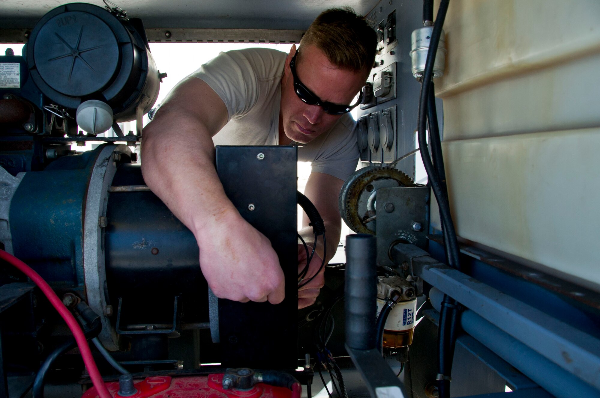 Tech. Sgt. Nick Meyst, 446th Aerospace Ground Equipment Squadron AGE technician, tests the voltage regulator on the generator of a flood light at Naval Station Rota, Spain, February 23, 2016.  Meyst received a coin from the 725th Air Mobility Squadron commander for his efforts during the 446th Maintenance Group annual tour. (U.S. Air Force Reserve photo by Staff Sgt. Madelyn McCullough)