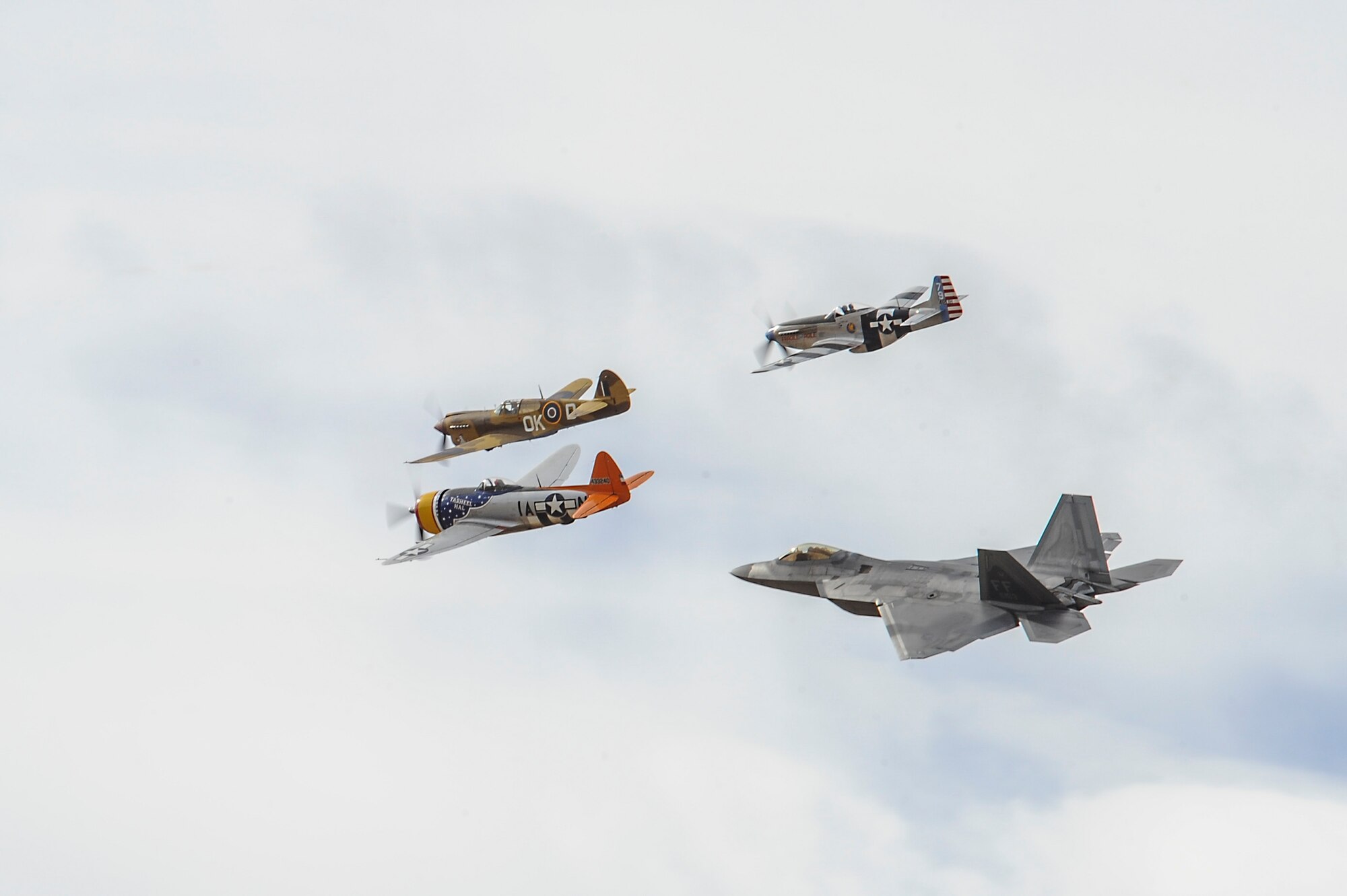 Two P-51 Mustangs, a P-47 Thunderbolt and a U.S. Air Force F-22 Raptor fly in formation during the 2016 Heritage Flight Training and Certification Course at Davis-Monthan Air Force Base, Ariz., March 6, 2016. The annual aerial demonstration training event has been held at D-M since 2001. The aircraft that participated in this year’s HFTCC were the F-35 Lightning II, the F-22 Raptor and the F-16 Fighting Falcon. The historic aircraft included the P-51 Mustang, the P-40 Warhawk, the P-38 Lightning, the P-47 Thunderbolt, the TF-51 Mustang and the F-86 Sabre. (U.S. Air Force photo by Airman 1st Class Mya M. Crosby/Released)