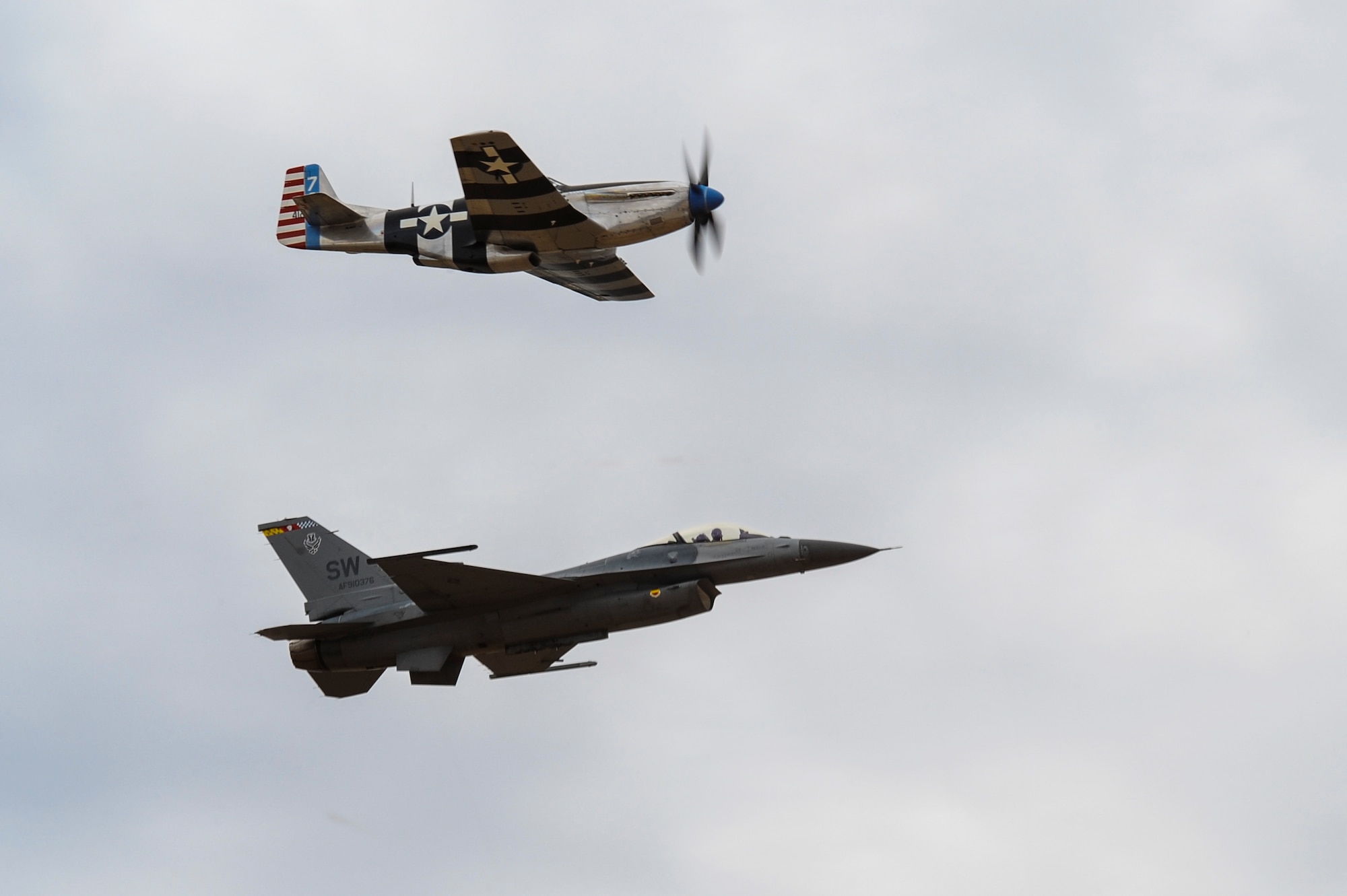 A P-51 Mustang and an F-16C Fighting Falcon fly in formation together during the 2016 Heritage Flight Training and Certification Course at Davis-Monthan Air Force Base, Ariz., March 6, 2016. Established in 1997, the HFTCC certifies civilian pilots of historic military aircraft and U.S. Air Force pilots to fly in formation together during the upcoming air show season. (U.S. Air Force photo by Airman 1st Class Mya M. Crosby/Released)