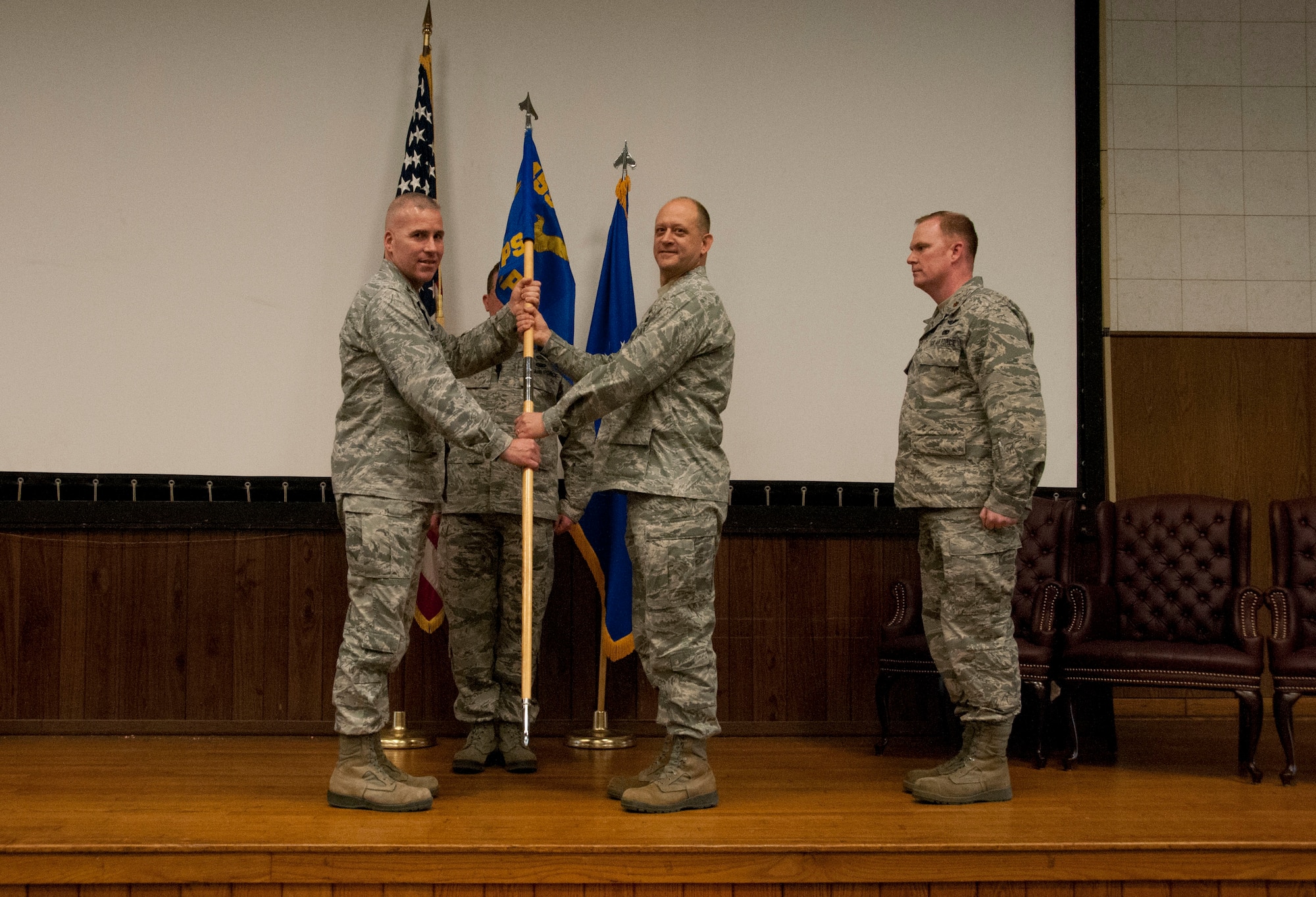 Colonel Randy Stoeckmann, commander of the 459th Mission Support Group, Joint Base Andrews, Maryland, hands Maj. Justin O’Brien, commander of the 69th Aerial Port Squadron, the 69th APS guidon at a change of command ceremony March 5, 2016. Major Robert Hamilton relinquished command to O’Brien, who is returning to the 69th APS after having served with the squadron twice before as an enlisted Airman and a company grade officer. (U.S. Air Force photo/Staff Sgt. Tiffany Lindemann)