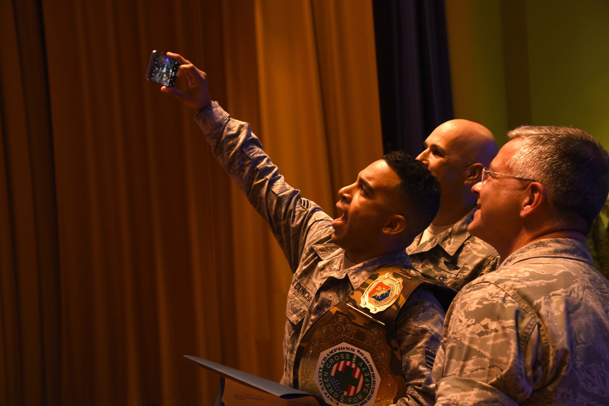 U.S. Air Force Senior Airman Kevin De La Concha takes a photo during the Annual Awards Ceremony held at MacDill Air Force Base, Florida. The annual awards ceremony was the first one in 927th Air Refueling Wing history. (U.S. Air Force photo by Senior Airman Xavier Lockley)