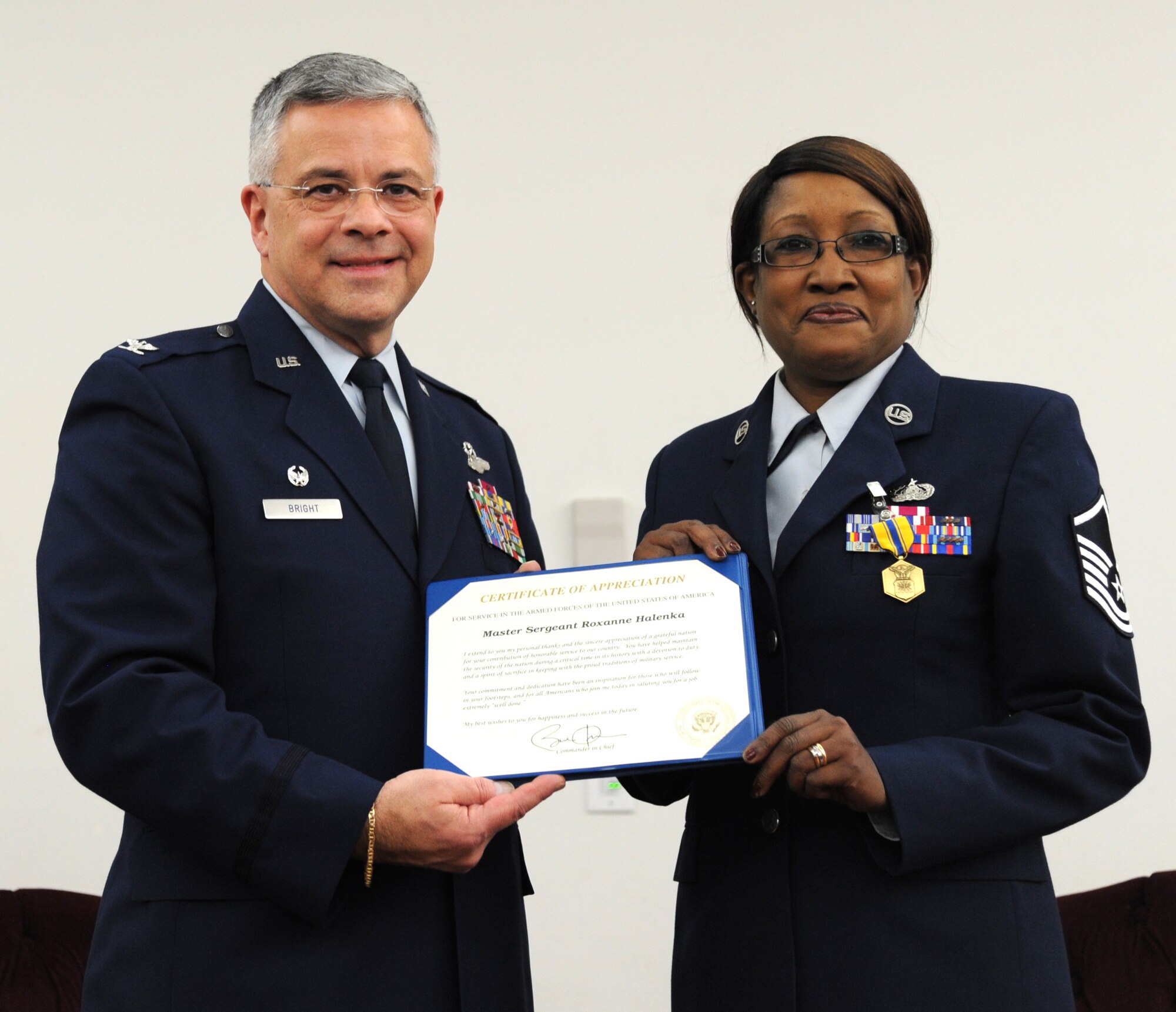 U.S. Air Force Master Sgt. Roxanne Helenka 927th Force Support Squadron chief of knowledge management, accepts her certificate of appreciation from Col. Randall Bright, 927 Air Refueling Wing commander during Helenka’s retirement ceremony on Feb. 6, 2016 at MacDill Air Force Base, Florida. Helenka served faithfully for 26 years in the knowledge operations career field with assignments at McConnell AFB, Kansas and MacDill AFB. (U.S. Air Force photo by Senior Airman Xavier Lockley)